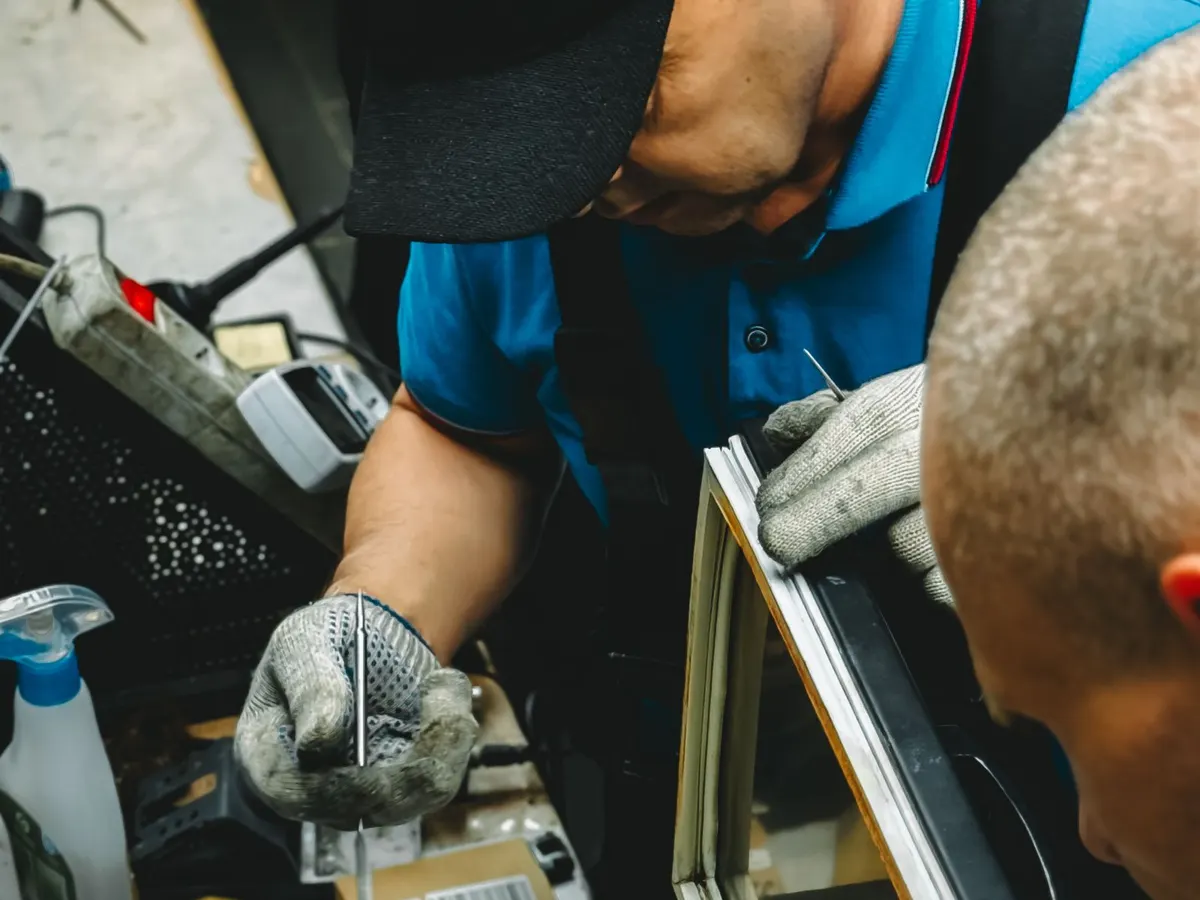 Two technicians repairing a commercial refrigeration unit